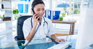 Medical Practice desk - Woman talking on the phone