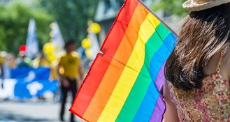 Woman with a LGBT parade flag