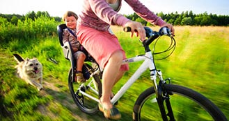 Woman riding a bike with her children