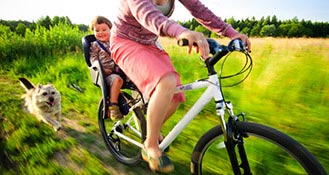 Woman riding a bike with her children