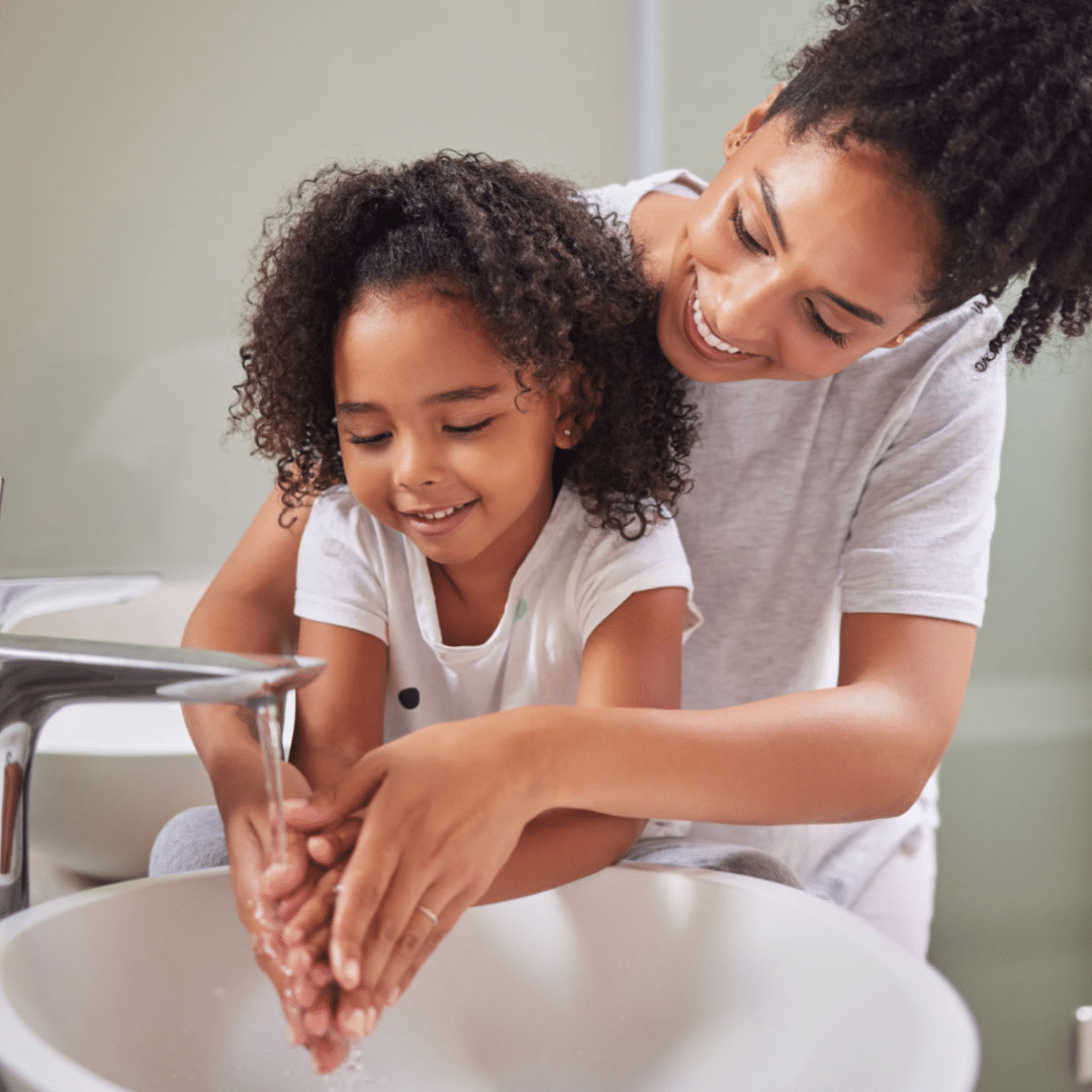 mother handwashing with child